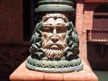 Close-up of buddha statue against built structure