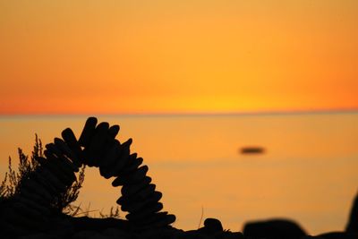 Scenic view of sea against orange sky