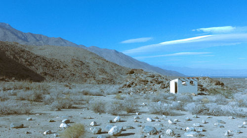 Scenic view of mountain against blue sky