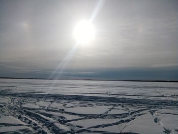 Scenic view of snow covered landscape against sky during sunset