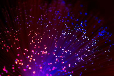 Close-up of illuminated fiber optic against black background