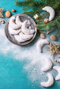 High angle view of sweet food in plate by pine needle at table