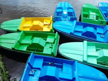 High angle view of multi colored boats moored in water