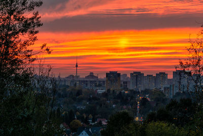 High angle view of trees and buildings against sky during sunset