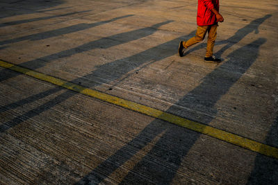 Low section of man walking on street