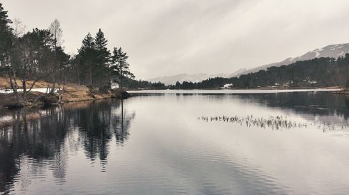 Scenic view of lake and mountains against sky