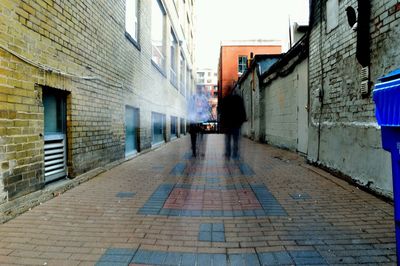 People walking on alley in city