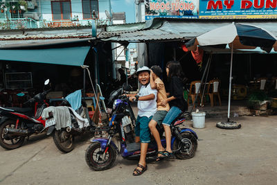 Portrait of people sitting on motorcycle