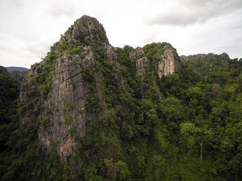 Low angle view of rocks on mountain against sky