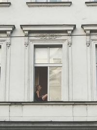 Full length of man on window