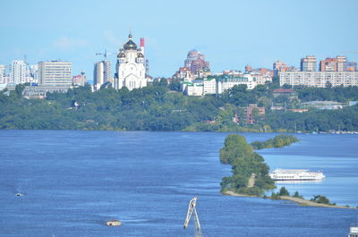 View of buildings and sea against sky