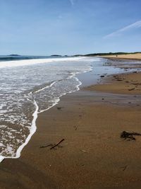 Scenic view of beach against blue sky