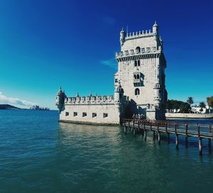 Historic building in venetian lagoon against blue sky