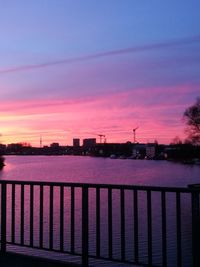 Scenic view of river against sky at sunset