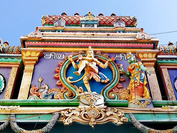 Low angle view of statue against temple