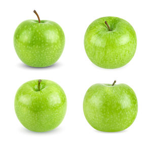 Close-up of green apple against white background