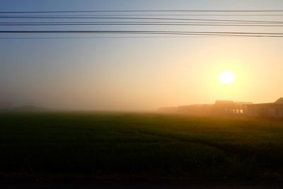 Scenic view of field against sky during sunset