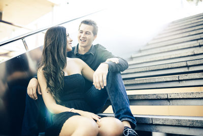 Young couple sitting on steps