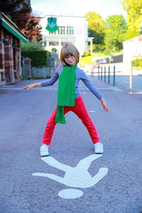 Full length portrait of smiling girl playing