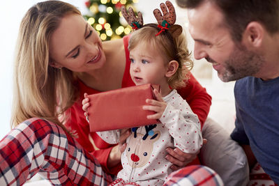 Family with gift at home