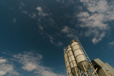 Low angle view of industrial building against sky