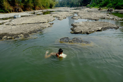 High angle view of man swimming in lake