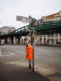 Information sign in city against sky