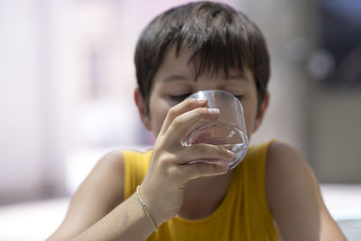 Close-up of teenage boy drinking water