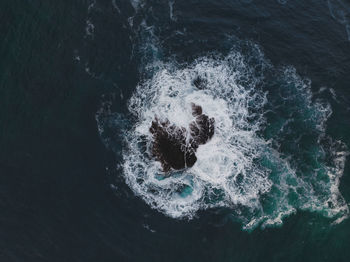 High angle view of waves splashing on shore