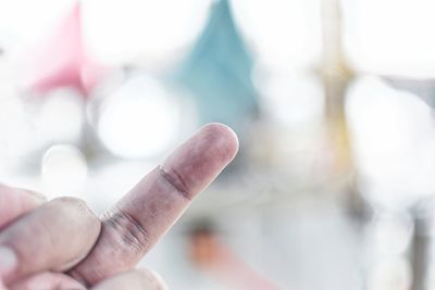 Cropped image of person showing middle finger