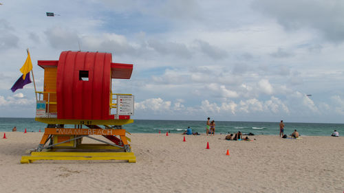 Lifeguard hut on beach against sky