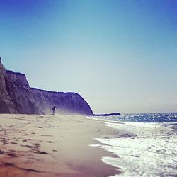 Scenic view of beach against blue sky