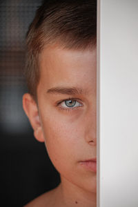 Close-up portrait of young boy looking at camera