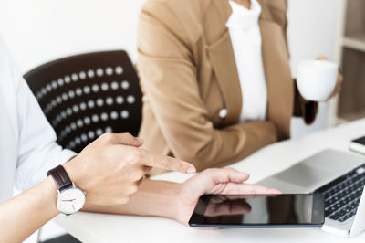 Midsection of woman using smart phone