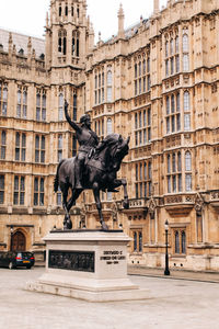 Statue in front of historical building