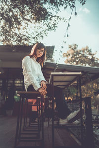 Woman sitting on bench in park