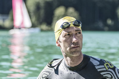 Close-up of man wearing swimming goggles in sea