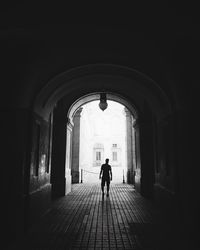 Rear view of woman walking in corridor