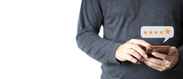 Midsection of businessman using mobile phone against white background