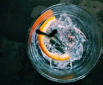 High angle view of ice in glass, gin and tonic