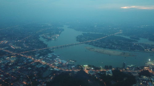 High angle view of buildings by sea against sky