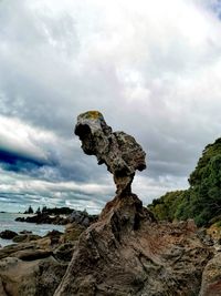 Low angle view of rock formation against sky