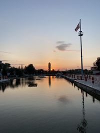 Scenic view of lake against sky at sunset