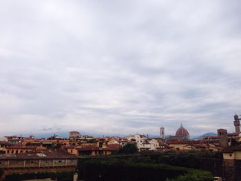 Cityscape against cloudy sky