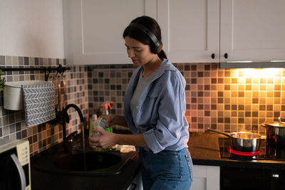 Young woman standing at home