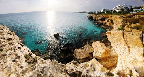 Scenic view of rocks in sea against sky