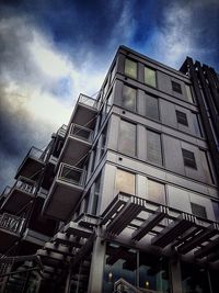 Low angle view of building against cloudy sky