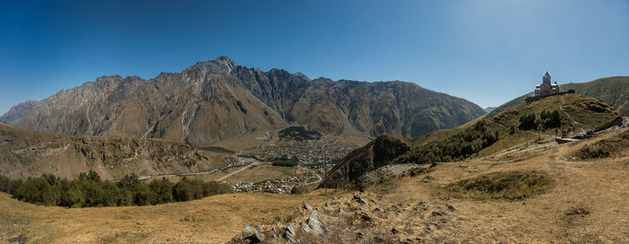 Panoramic view of mountains against clear sky