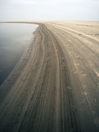 Tire tracks on sandy beach