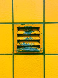 Full frame shot of yellow vent and tiles